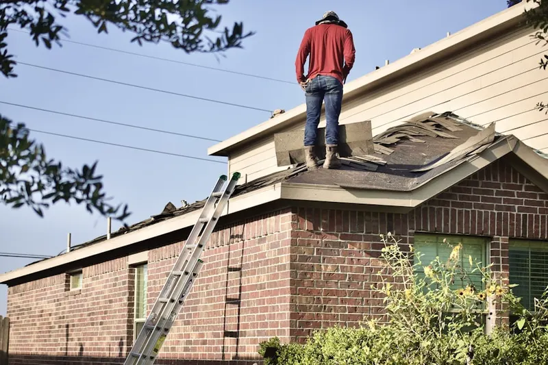 Professional roofer working on a residential roof in Imlay